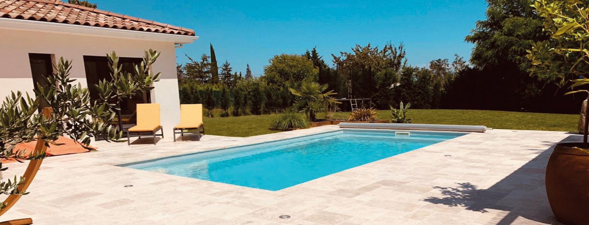 Contemporary fibreglass swimming pool in a landscaped garden