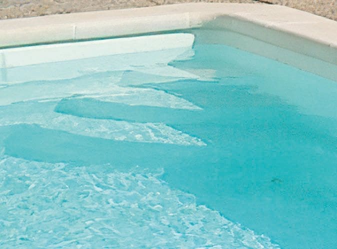 Norma fibreglass swimming pool installed in a landscaped garden