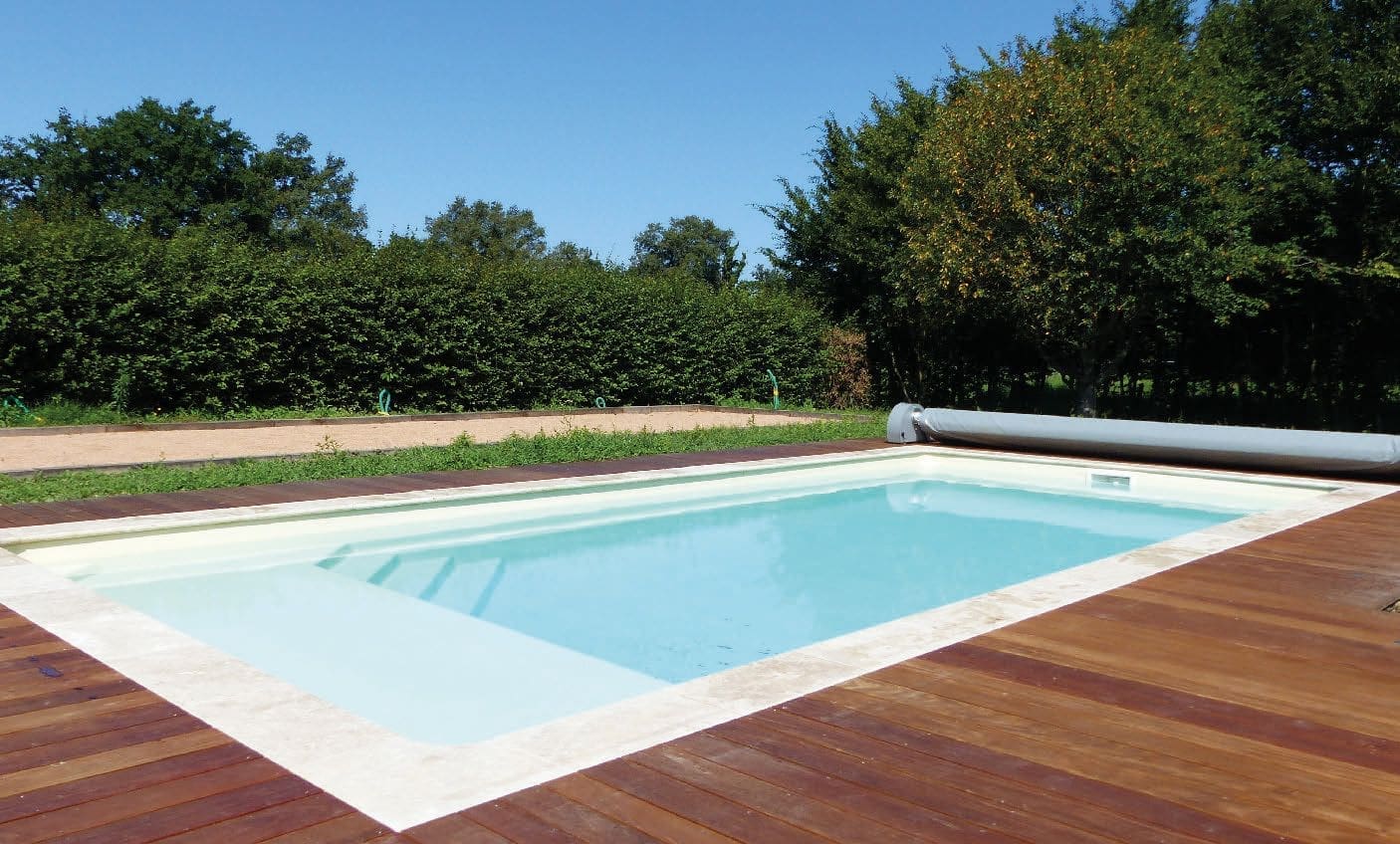 Relaxation fibreglass swimming pool in a landscaped garden