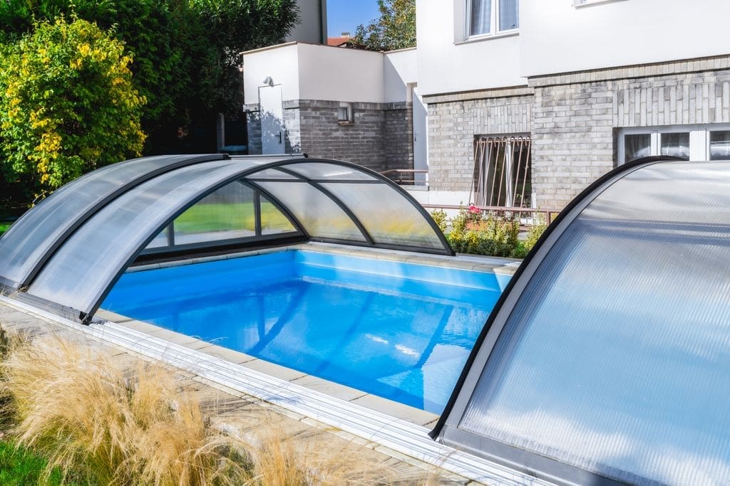 Eight metre skimmer swimming pool with Klasik B telescopic enclosure